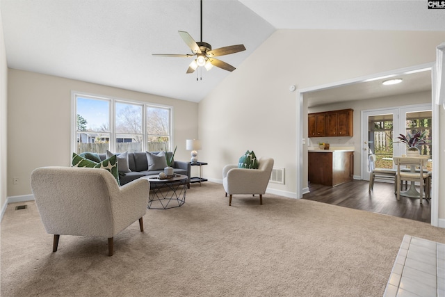 living room with visible vents, a healthy amount of sunlight, and carpet floors