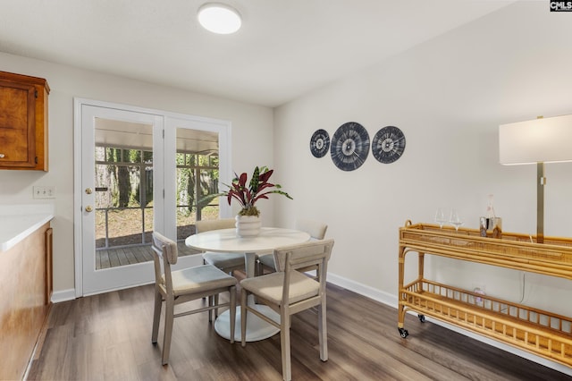 dining room with dark wood finished floors and baseboards