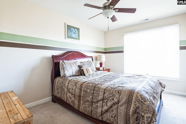 bedroom featuring visible vents, carpet floors, baseboards, and a ceiling fan