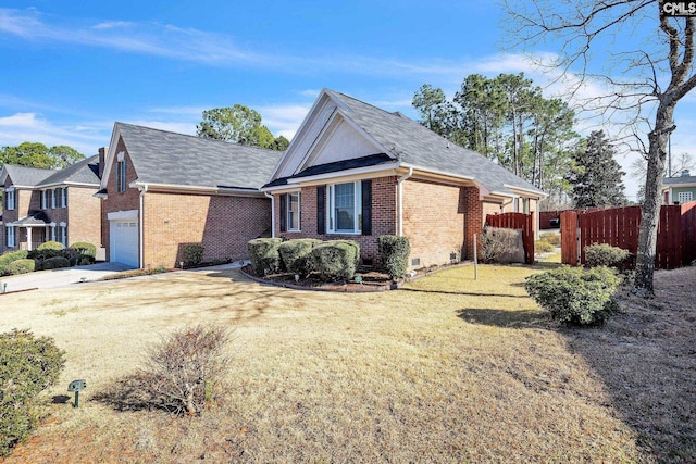 view of front facade featuring driveway, fence, a front yard, crawl space, and brick siding