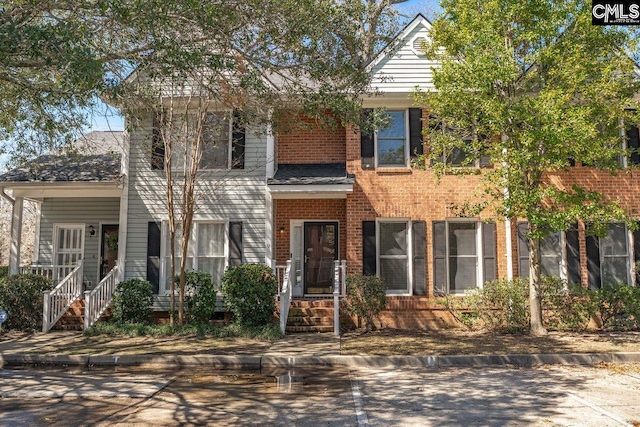 view of front of house featuring brick siding