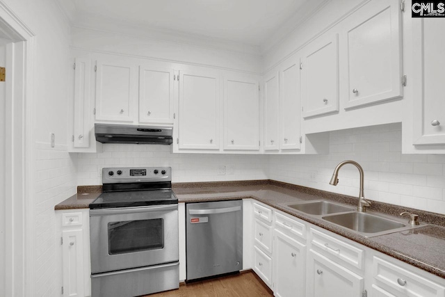 kitchen featuring a sink, white cabinets, appliances with stainless steel finishes, under cabinet range hood, and dark countertops