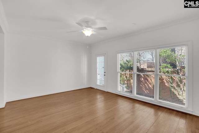 spare room with ceiling fan, baseboards, wood finished floors, and ornamental molding