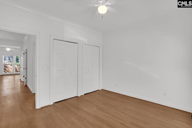 unfurnished bedroom featuring light wood-style flooring, a ceiling fan, crown molding, and baseboards