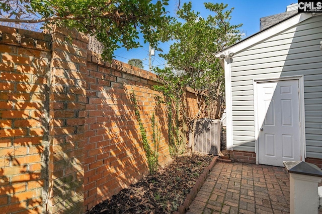 view of patio / terrace with central AC unit and fence