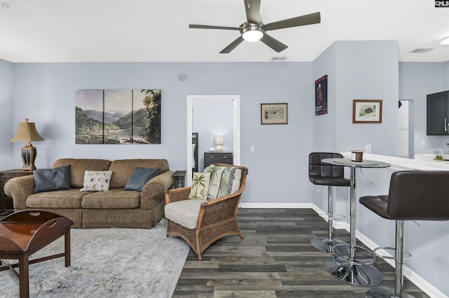 living room featuring visible vents, a ceiling fan, dark wood-type flooring, and baseboards