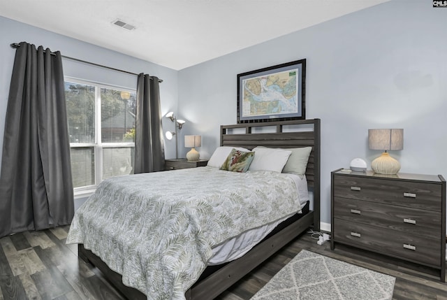 bedroom with visible vents and dark wood-style floors