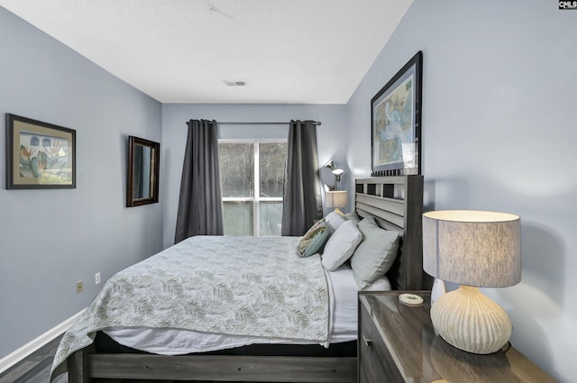 bedroom with visible vents and baseboards