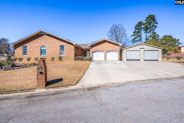 ranch-style home featuring a garage, brick siding, and driveway