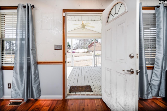 entryway with a wealth of natural light, visible vents, baseboards, and hardwood / wood-style floors