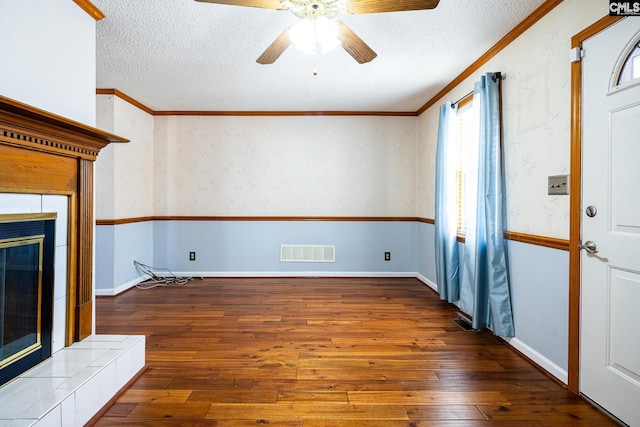 unfurnished living room featuring hardwood / wood-style floors, a fireplace, visible vents, and a textured ceiling