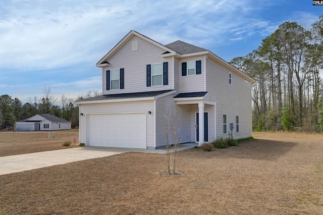 traditional-style house with concrete driveway, an attached garage, and a shingled roof