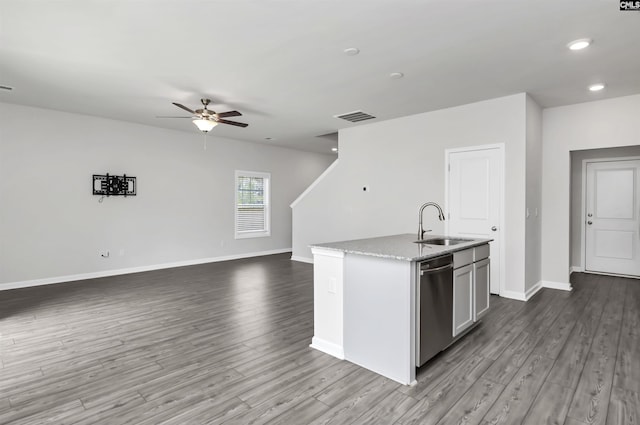 kitchen with visible vents, baseboards, dishwasher, wood finished floors, and a sink