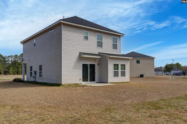 rear view of house with a patio and a yard