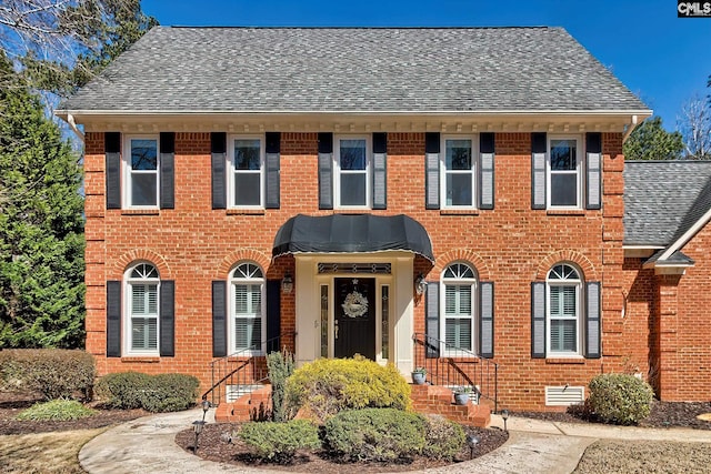 view of front of home featuring crawl space, brick siding, and a shingled roof