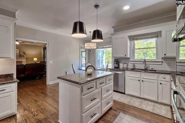 kitchen with backsplash, dishwasher, ornamental molding, dark wood-style floors, and a sink