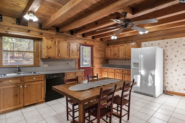 kitchen featuring wallpapered walls, a sink, white refrigerator with ice dispenser, dishwasher, and beamed ceiling