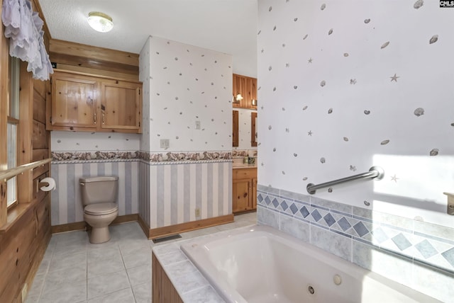 full bathroom featuring vanity, wallpapered walls, a whirlpool tub, tile patterned floors, and toilet