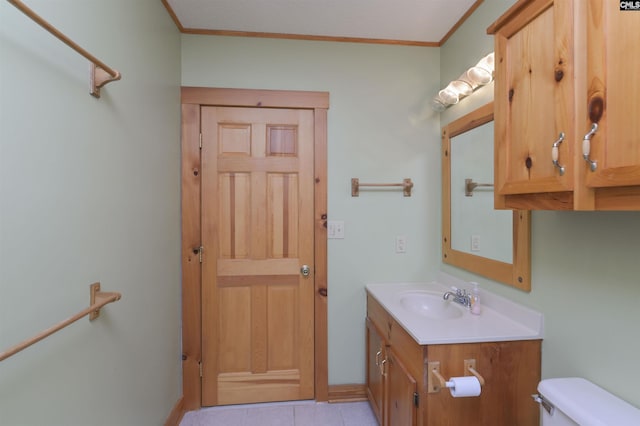 bathroom featuring vanity, crown molding, toilet, and tile patterned flooring