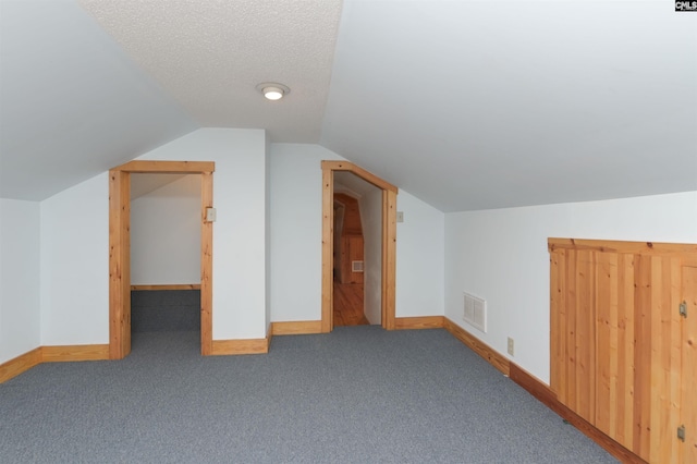 bonus room with lofted ceiling, baseboards, visible vents, and carpet floors