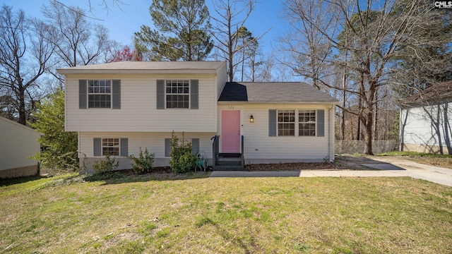 tri-level home with a front yard