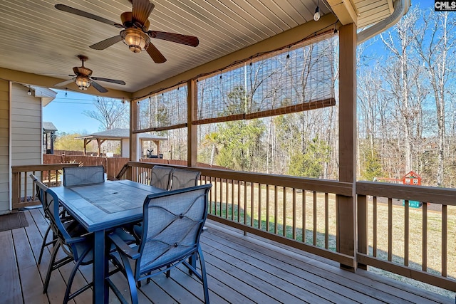 deck featuring outdoor dining area and ceiling fan