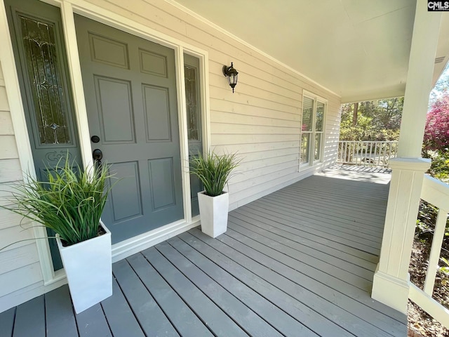 wooden terrace featuring a porch