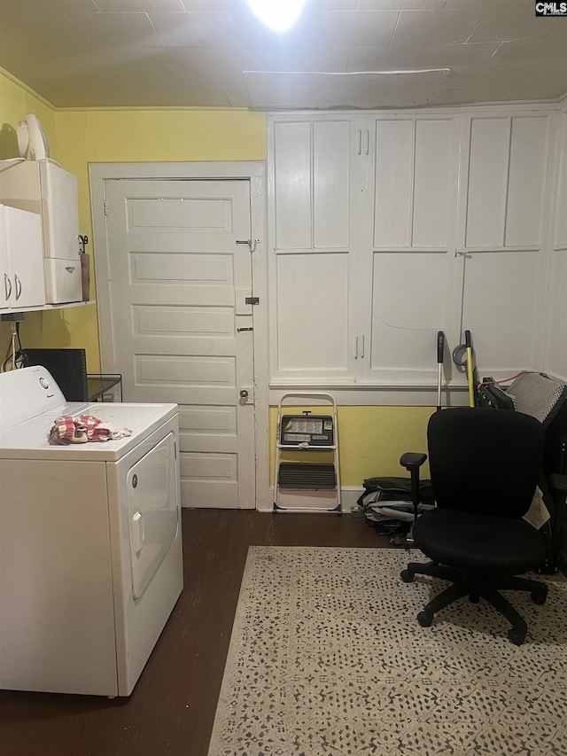 laundry area featuring dark wood-style floors, cabinet space, and washer / clothes dryer