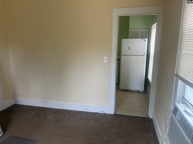 interior space with tile patterned flooring, carpet flooring, and baseboards