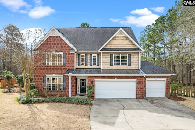 view of front of house with brick siding, fence, concrete driveway, a garage, and a standing seam roof