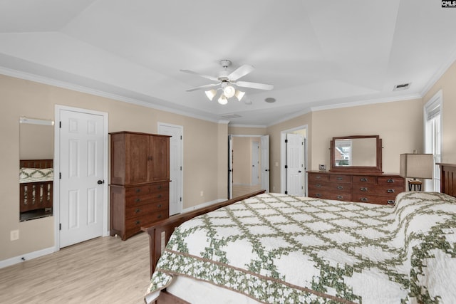 bedroom with a ceiling fan, baseboards, visible vents, ornamental molding, and light wood-type flooring