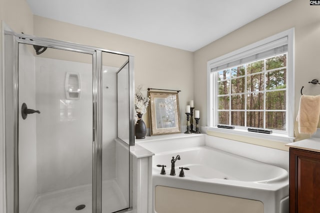 full bathroom featuring a bath, a shower stall, and vanity