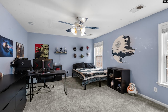 carpeted bedroom with baseboards, visible vents, and ceiling fan