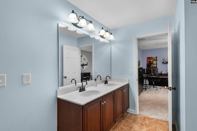 bathroom with a sink, double vanity, and tile patterned floors