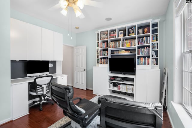 office area featuring baseboards, dark wood finished floors, and a ceiling fan