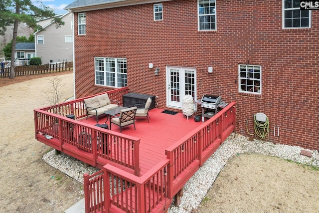 deck featuring outdoor lounge area, area for grilling, and fence