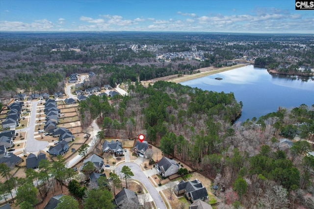 birds eye view of property with a forest view and a water view