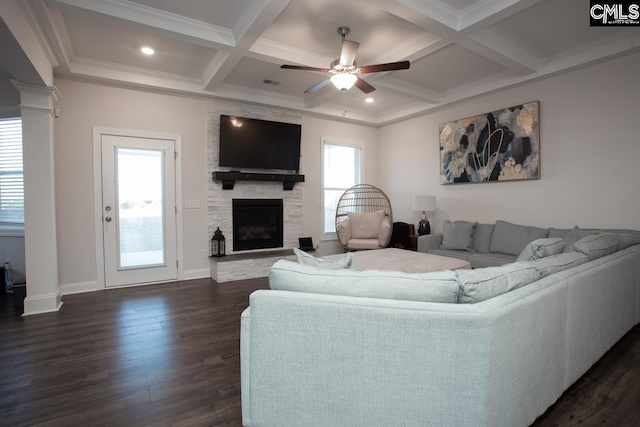 living area with a ceiling fan, coffered ceiling, ornate columns, a fireplace, and dark wood-type flooring