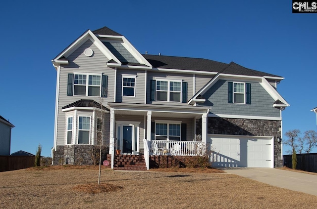 view of front of home featuring concrete driveway, an attached garage, covered porch, and stone siding