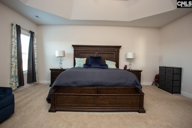 bedroom with light carpet, visible vents, and baseboards