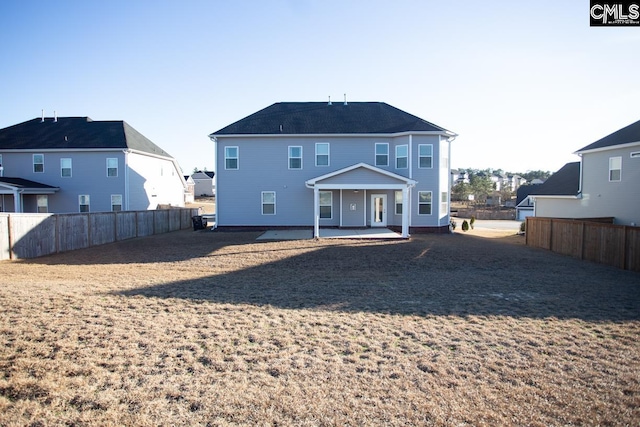 back of house featuring a patio and fence