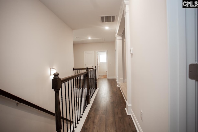 hall with visible vents, an upstairs landing, dark wood-type flooring, baseboards, and attic access