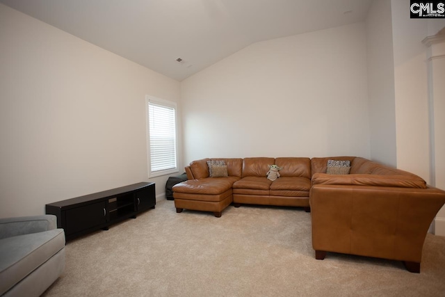 living area featuring lofted ceiling and light colored carpet