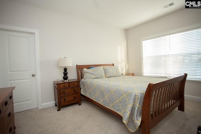 carpeted bedroom with visible vents and baseboards