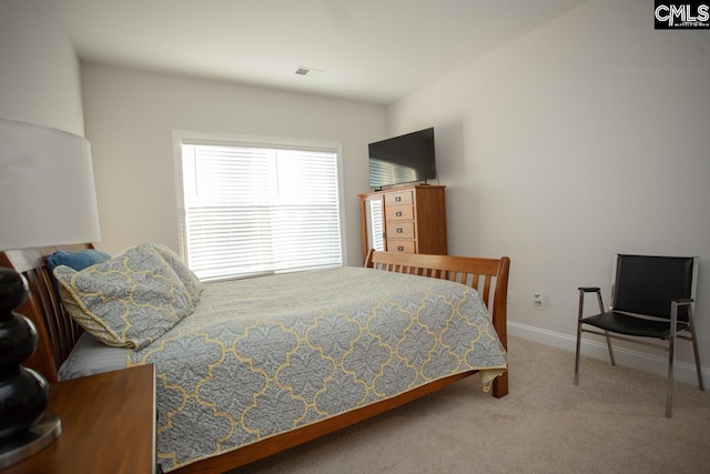 bedroom with baseboards, visible vents, and carpet floors