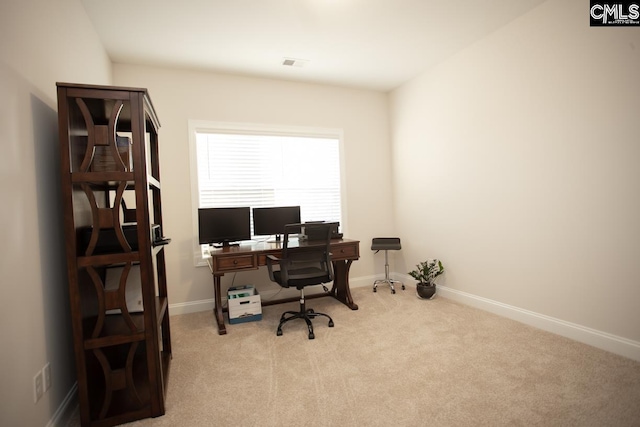 carpeted office with visible vents and baseboards