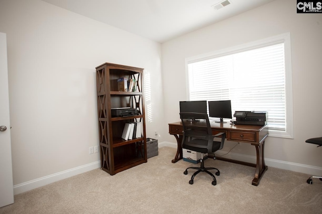 office space featuring visible vents, plenty of natural light, and light colored carpet