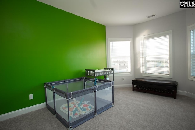 bedroom featuring visible vents, baseboards, and carpet floors