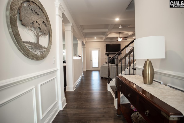 corridor featuring beamed ceiling, coffered ceiling, dark wood-style floors, stairs, and ornate columns