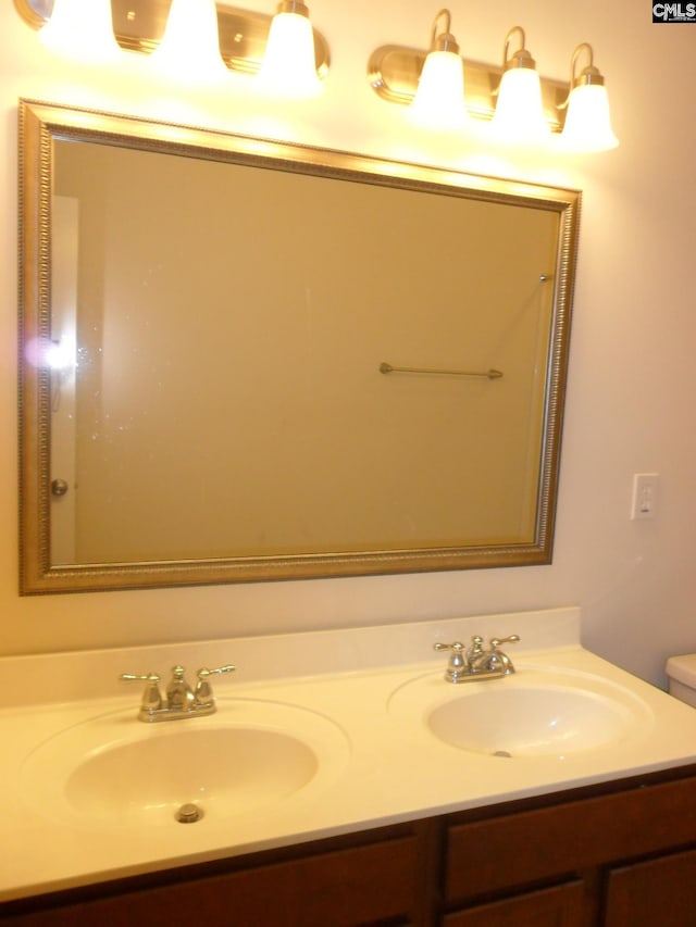 bathroom with a sink and double vanity